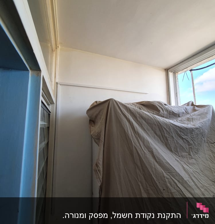 חדר עם קיר לבן וחלון, ללא אלמנטים חשמליים נראים לעין.